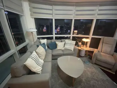 a living room with a couch and a table at 1BR Premium condo - Twin Oaks Pl PANORAMIC VIEW in Manila