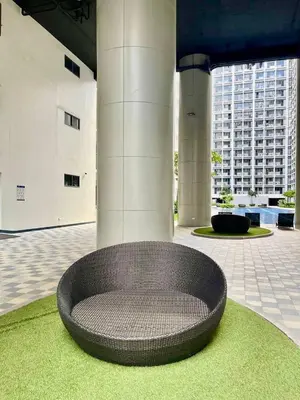 a circular seating area in a building with green grass at Hotel-Like Staycation1 MOA Pasay in Manila