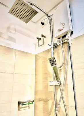 a shower in a bathroom with a shower head at Hotel-Like Staycation1 MOA Pasay in Manila