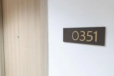 a close up of a door with a clock on it at Hotel-Like Staycation1 MOA Pasay in Manila