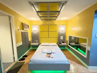 a room with a bed and two sinks in it at Town and Country Reposo in Manila