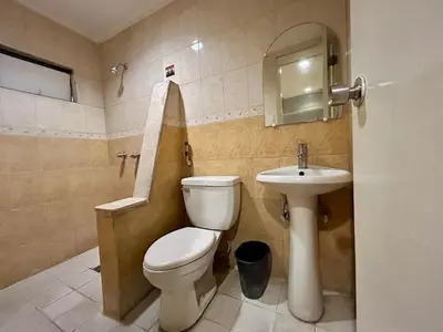 a bathroom with a toilet and a sink at Town and Country Reposo in Manila