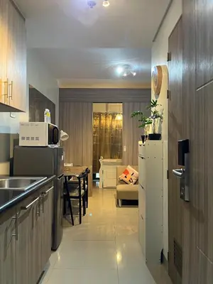 a kitchen with a white refrigerator and a table at SMDC Good Stays Shore 2 - Unit 1289 Tower 2 in Manila
