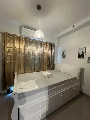 a white bed in a room with a window at SMDC Good Stays Shore 2 - Unit 1289 Tower 2 in Manila