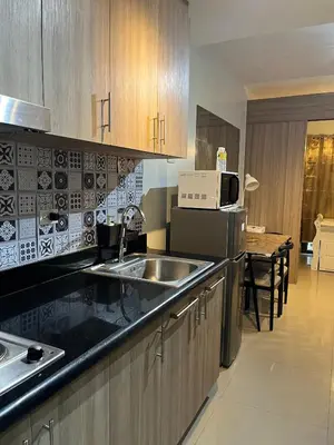 a kitchen with a sink and a microwave at SMDC Good Stays Shore 2 - Unit 1289 Tower 2 in Manila