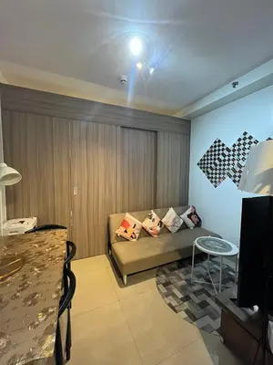 a living room with a couch and a table at SMDC Good Stays Shore 2 - Unit 1289 Tower 2 in Manila