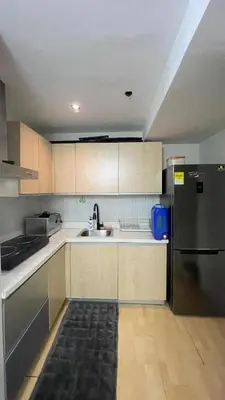 a kitchen with a sink and a refrigerator at The Gramercy Residences Unit for Rent in Manila