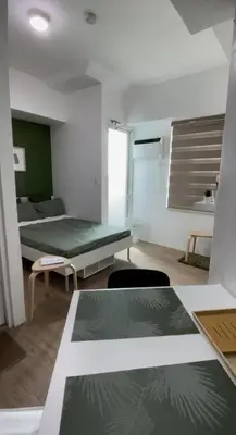 a room with a bed and a table and chairs at Cozy aesthetic stay near Alabang in Manila