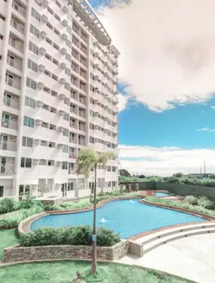 a large apartment building with a large swimming pool at Cozy aesthetic stay near Alabang in Manila
