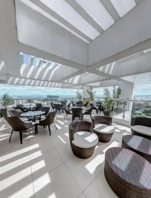 a restaurant with tables and chairs and a balcony at Cozy aesthetic stay near Alabang in Manila