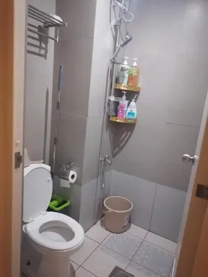 a small bathroom with a toilet and a shower at pierrecondotel in Manila