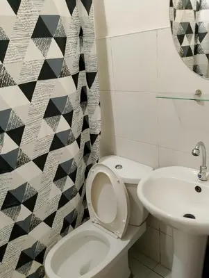 a bathroom with a toilet and a sink at Kassel DORZ Hostel Bldg 16 Condostaycation in Manila