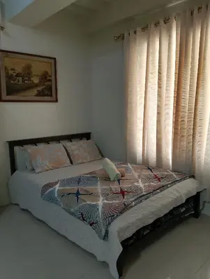 a bed sitting in a bedroom with a window at Kassel DORZ Hostel Bldg 16 Condostaycation in Manila