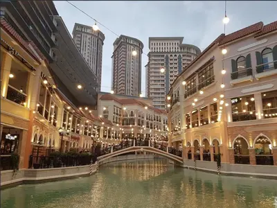 a canal in a city with buildings and a bridge at Luxury Apartment with PA, Skyline View & Top Amenities in Manila