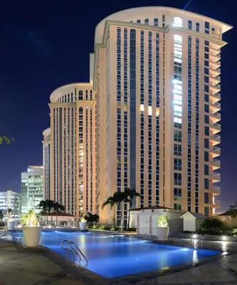 a large building with blue lights in front of it at Luxury Apartment with PA, Skyline View & Top Amenities in Manila