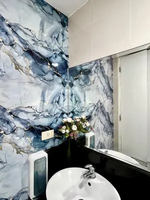 a bathroom with a sink and a blue marble wall at Elevated Staycation BGC Venice Grand Canal in Manila