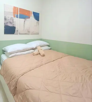 a bed with a stuffed animal on top of it at Condo in Pasay near MOA PICC World Trade Center in Manila