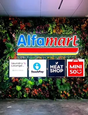 a group of signs on a wall with plants at Condo in Pasay near MOA PICC World Trade Center in Manila