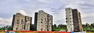 three tall buildings in a field with a car at Monteluce Condominium Apartment in Silang