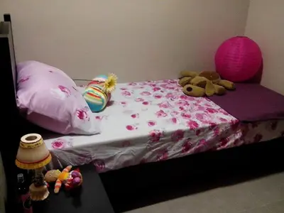 a pink bed with two stuffed animals on it at Monteluce Condominium Apartment in Silang