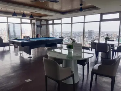a pool table in a room with windows at 2br Condo Coast Residence near MOA NAIA Ayala WTC in Manila