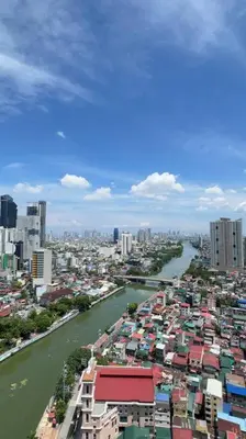 a view of a city with a river and buildings at Staycation at ACQUA The Hotel Residences Novotel Tower in Manila