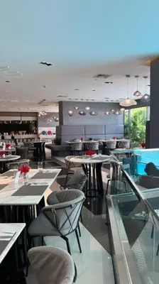 a restaurant with tables and chairs in a room at Staycation at ACQUA The Hotel Residences Novotel Tower in Manila