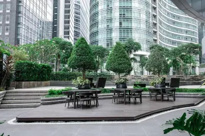 a courtyard with tables and chairs in a city at Marina- Avant BGC parking w fee in Manila