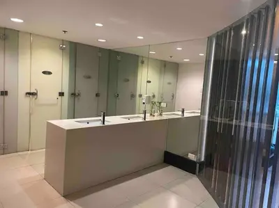 a bathroom with two sinks and a large mirror at Marina- Avant BGC parking w fee in Manila
