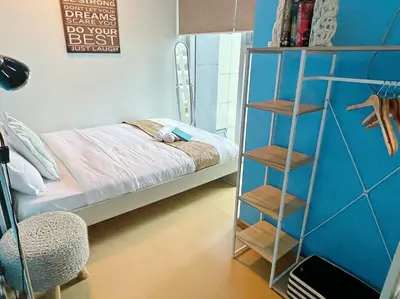 a bedroom with a bed and a book shelf at Marina- Avant BGC parking w fee in Manila
