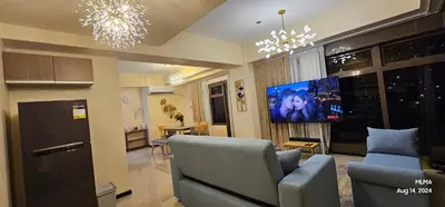 a living room with two chairs and a tv at Serenity by Zen Residences at The Radiance Manila Bay in Manila