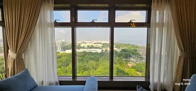 a room with a large window looking out at the city at Serenity by Zen Residences at The Radiance Manila Bay in Manila