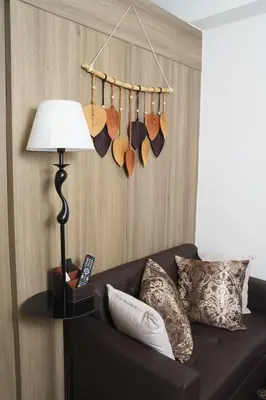 a living room with a couch and a lamp at Nordic Place Fame Residences 75 Smart Amenities Alexa 200mbps Wifi Netflix in Manila