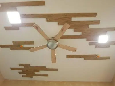 a clock with wooden arrows on a wall at Twin Oaks Place West Tower in Manila