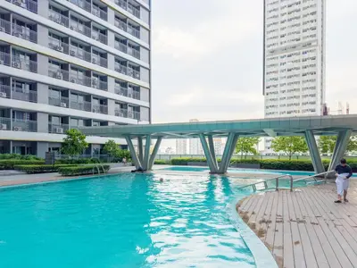 a bridge over a swimming pool in a building at GemstoneBR in SMDC Fame Residences in Manila