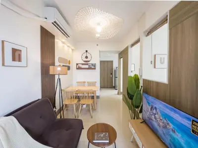 a living room with a couch and a table at GemstoneBR in SMDC Fame Residences in Manila