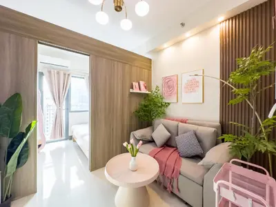a living room with a couch and a table at GemstoneBR in SMDC Fame Residences in Manila