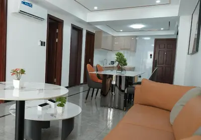a living room with two tables and a couch at Golden Seagulls Hotel in Manila