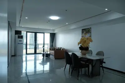 a living room with a table and chairs and a couch at Golden Seagulls Hotel in Manila