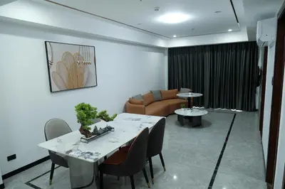 a living room with a table and a couch at Golden Seagulls Hotel in Manila