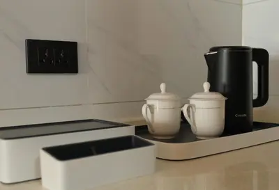 a counter with two coffee makers and a coffee pot at Golden Seagulls Hotel in Manila