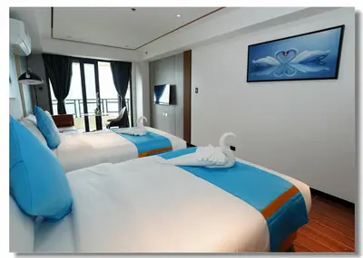 a hotel room with two beds and a television at Golden Seagulls Hotel in Manila