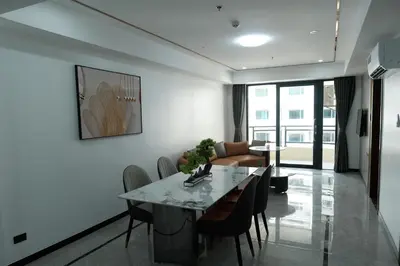 a living room with a table and chairs and a couch at Golden Seagulls Hotel in Manila