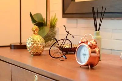 a wooden counter with a clock and a bike on it at Stylish 1BR Near US Embassy & Luneta with Pool & Gym in Manila