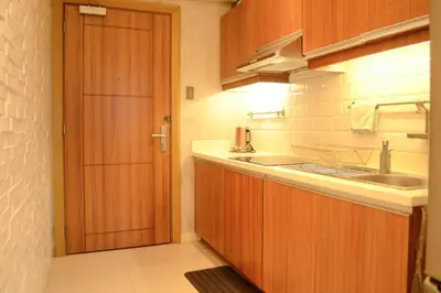 a kitchen with a wooden door and a sink at Stylish 1BR Near US Embassy & Luneta with Pool & Gym in Manila