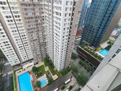 an overhead view of a city with tall buildings at One Uptown Executive 2 bedroom, with balcony, washer & Netflix in Manila