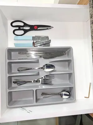 a drawer filled with silver utensils in a refrigerator at One Uptown Executive 2 bedroom, with balcony, washer & Netflix in Manila