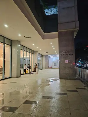 an empty lobby of a building at night at One Uptown Executive 2 bedroom, with balcony, washer & Netflix in Manila