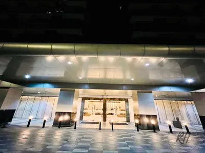 a lobby of a building with benches in front of it at Minimalist and Serene 1BR Condo Unit near MOA in Manila