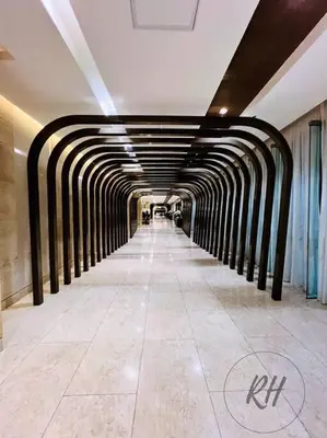 a long hallway of a building with a tunnel at Minimalist and Serene 1BR Condo Unit near MOA in Manila